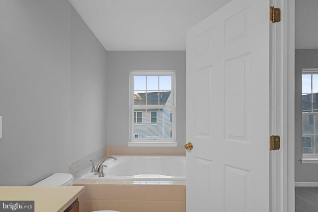 bathroom with tiled bath and toilet