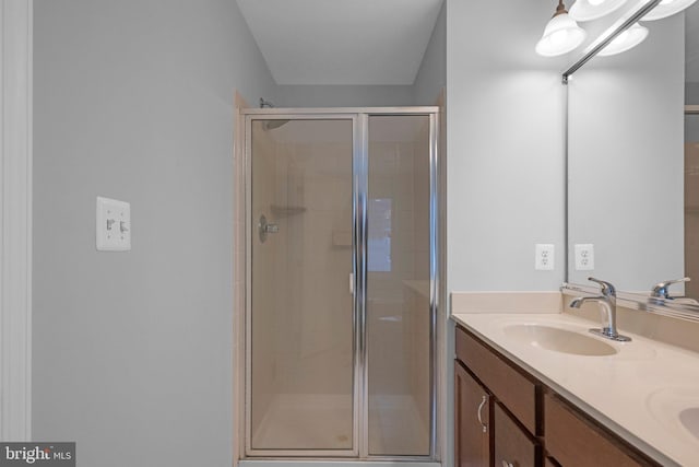 bathroom featuring vanity and an enclosed shower