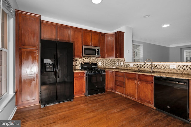 kitchen featuring dark wood-type flooring, black appliances, sink, light stone countertops, and tasteful backsplash