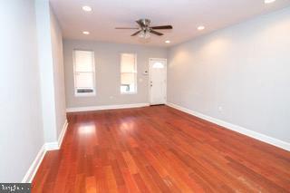 spare room featuring wood-type flooring and ceiling fan