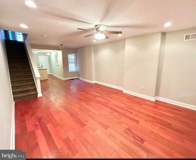 interior space featuring ceiling fan, wood-type flooring, and a textured ceiling