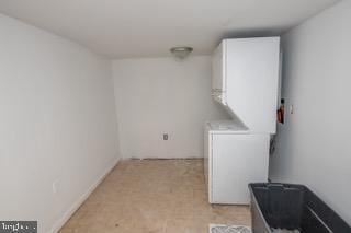 laundry room with stacked washing maching and dryer