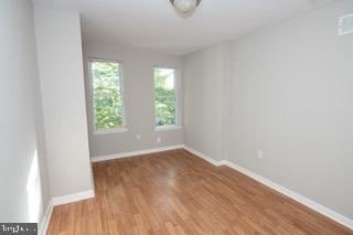 unfurnished room featuring light hardwood / wood-style floors and a healthy amount of sunlight