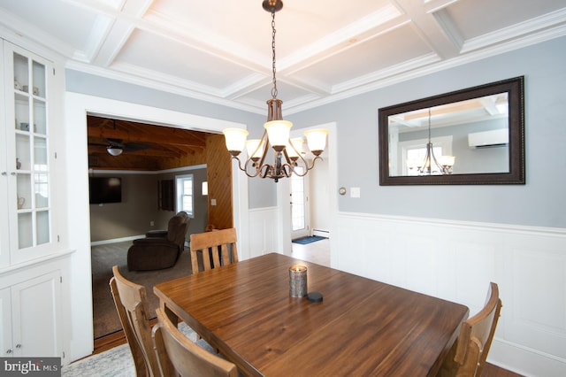 dining area featuring a notable chandelier, ornamental molding, a wall mounted AC, and coffered ceiling