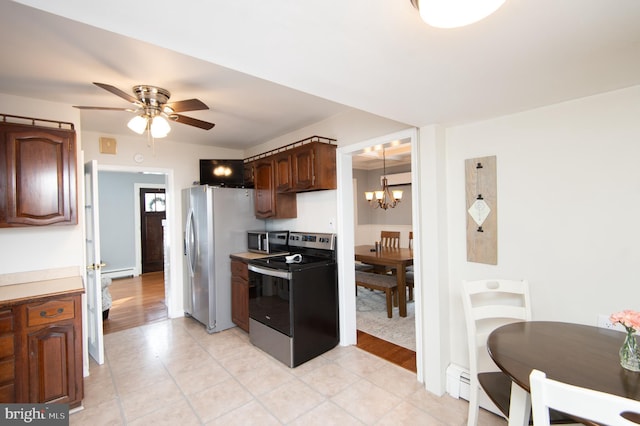 kitchen featuring appliances with stainless steel finishes, ceiling fan with notable chandelier, dark brown cabinetry, and a baseboard heating unit