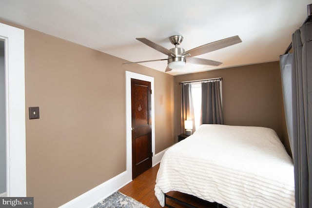 bedroom featuring dark hardwood / wood-style flooring and ceiling fan