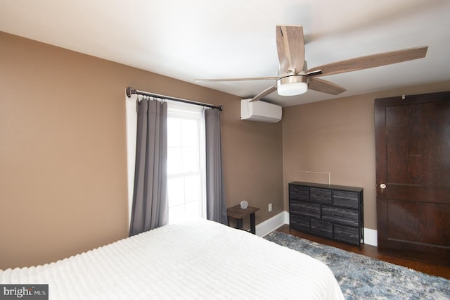 bedroom featuring ceiling fan, dark hardwood / wood-style floors, and a wall mounted AC