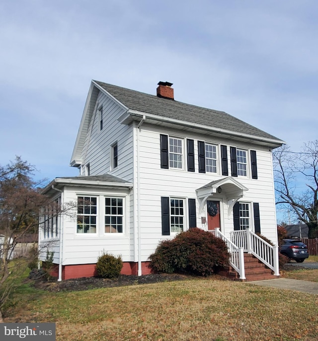 colonial-style house with a front yard