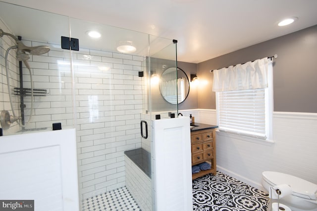 bathroom featuring an enclosed shower, vanity, toilet, and tile patterned flooring