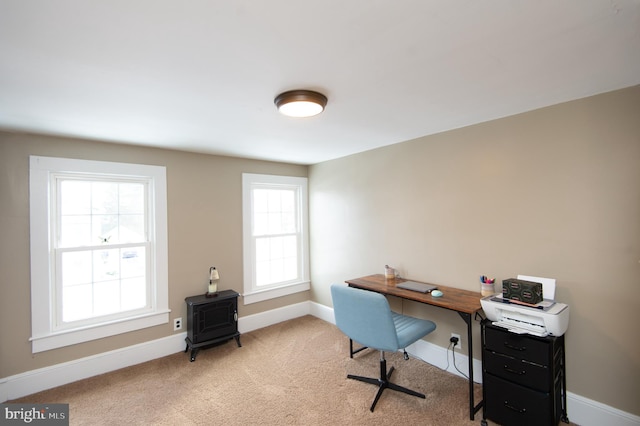 carpeted home office with a healthy amount of sunlight