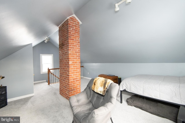 bedroom with light colored carpet and vaulted ceiling