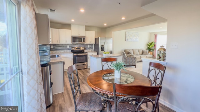 dining room with light hardwood / wood-style flooring