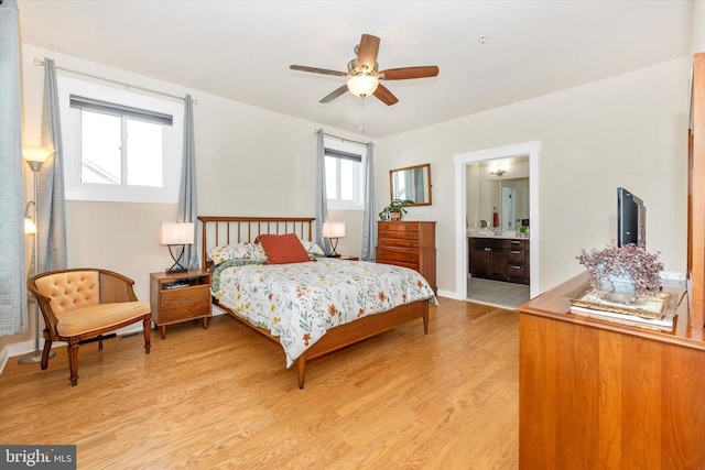 bedroom featuring ensuite bathroom, light hardwood / wood-style flooring, and ceiling fan