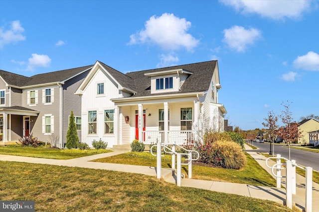 view of front of property with a front yard and a porch