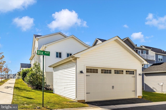 exterior space featuring a garage and a front yard