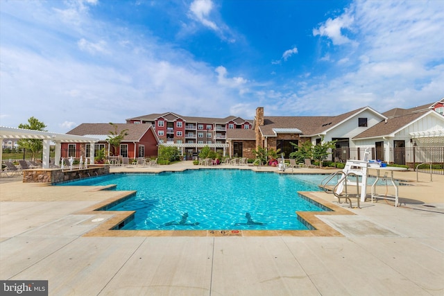 view of swimming pool featuring pool water feature, a patio area, and a pergola