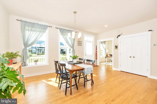 dining area featuring a chandelier and light hardwood / wood-style flooring