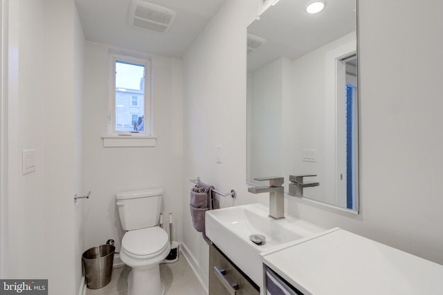 bathroom with tile patterned flooring, vanity, and toilet