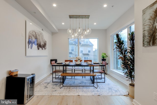 dining room featuring beverage cooler and light wood-type flooring