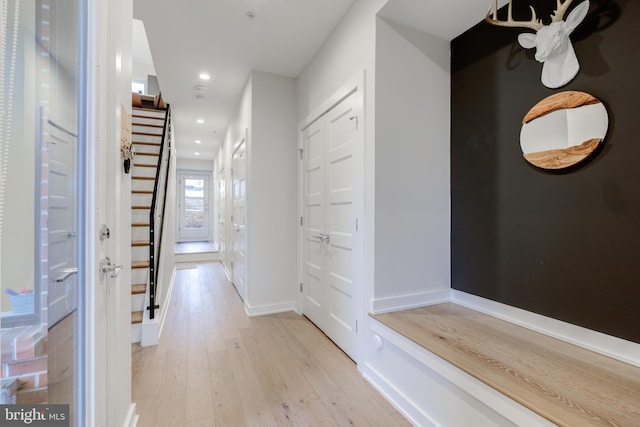 corridor with light hardwood / wood-style flooring