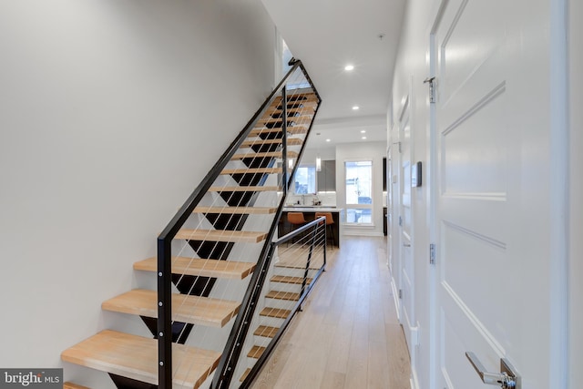 stairs featuring hardwood / wood-style flooring