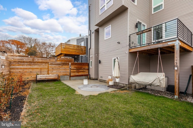 rear view of house with a patio and a lawn