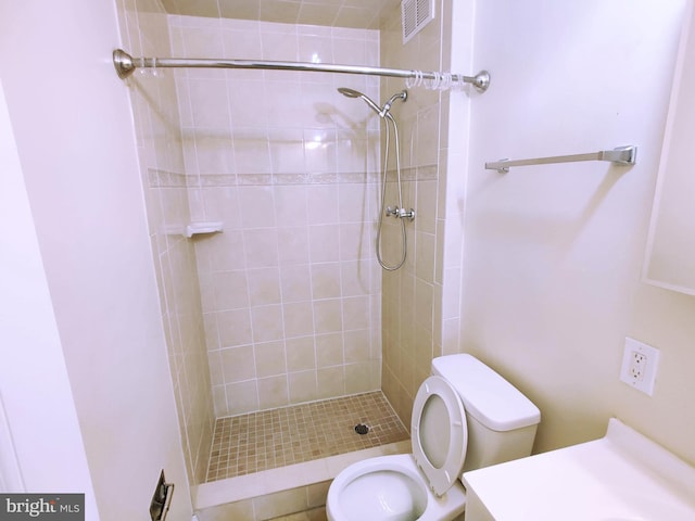 bathroom featuring toilet and tiled shower