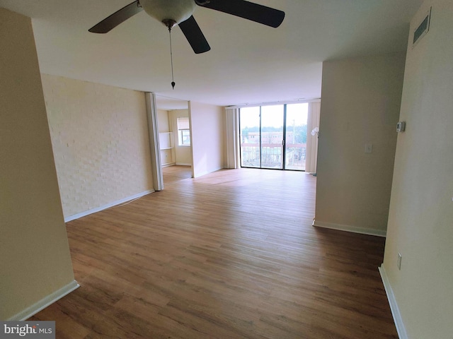 spare room featuring ceiling fan and dark wood-type flooring