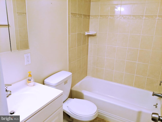 full bathroom with vanity, tiled shower / bath combo, and toilet