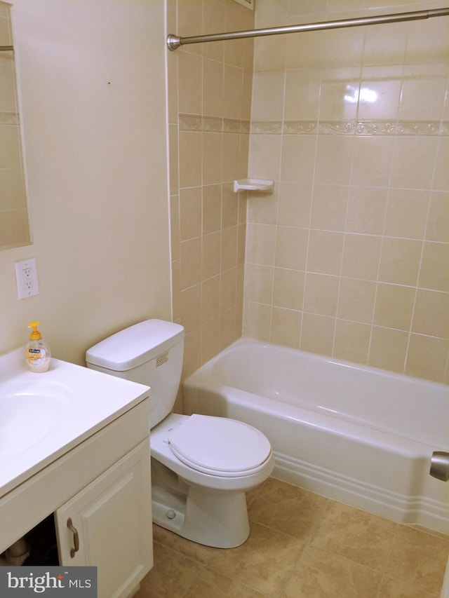 full bathroom with vanity, tiled shower / bath, and toilet