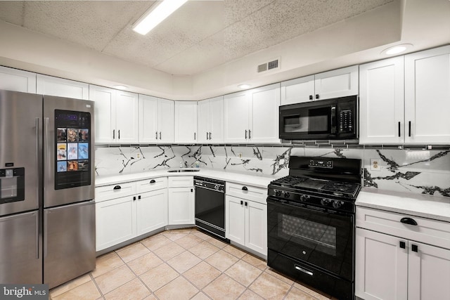 kitchen with tasteful backsplash, white cabinetry, and black appliances