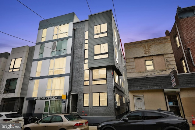 view of outdoor building at dusk