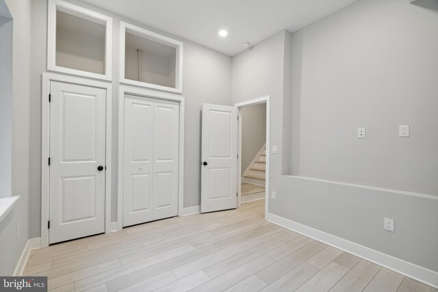 unfurnished bedroom featuring light hardwood / wood-style floors and a closet