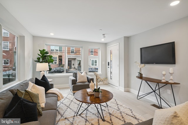 living room with a healthy amount of sunlight and light wood-type flooring