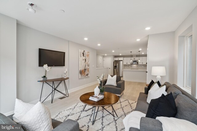 living room with light hardwood / wood-style flooring