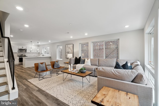 living room featuring dark hardwood / wood-style floors and a wealth of natural light