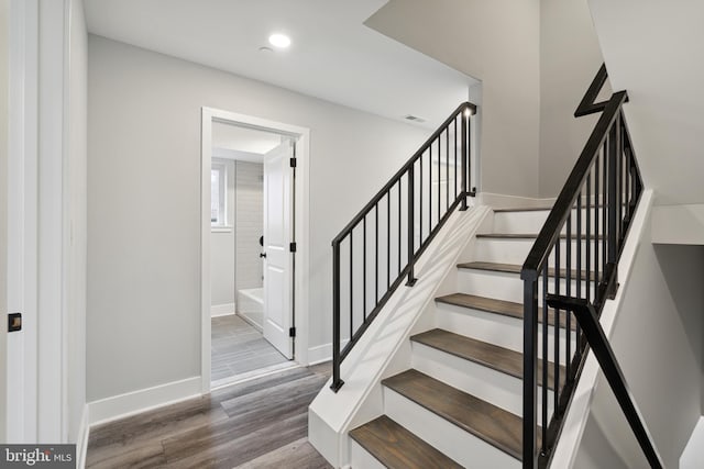 stairs featuring hardwood / wood-style flooring