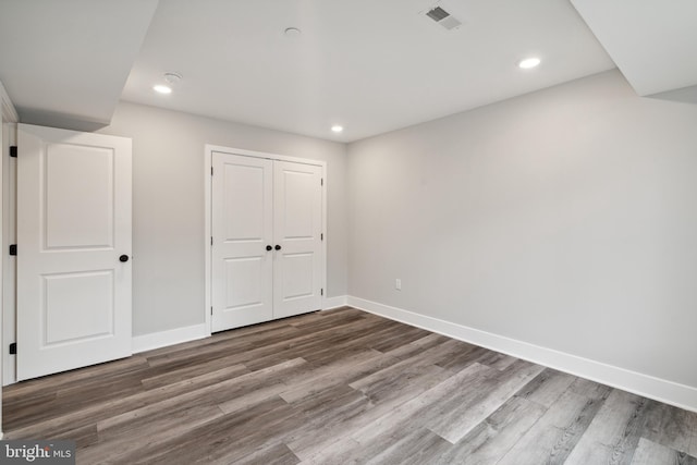 unfurnished bedroom featuring hardwood / wood-style flooring and a closet