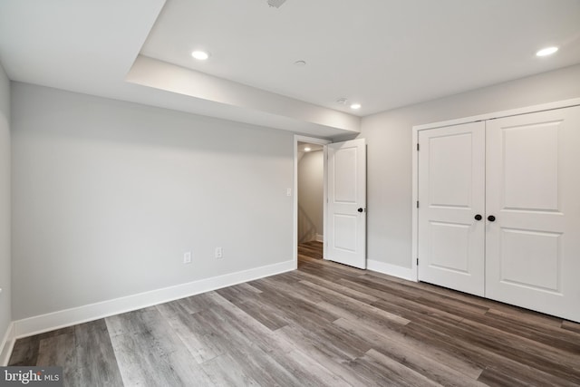 unfurnished bedroom featuring hardwood / wood-style floors and a closet