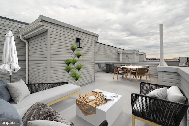 view of patio with an outdoor living space and central AC