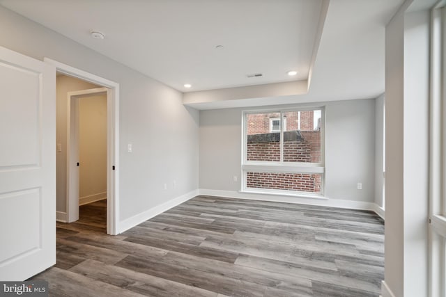 empty room with hardwood / wood-style flooring