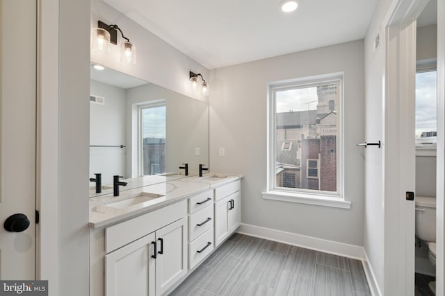 bathroom featuring vanity and toilet