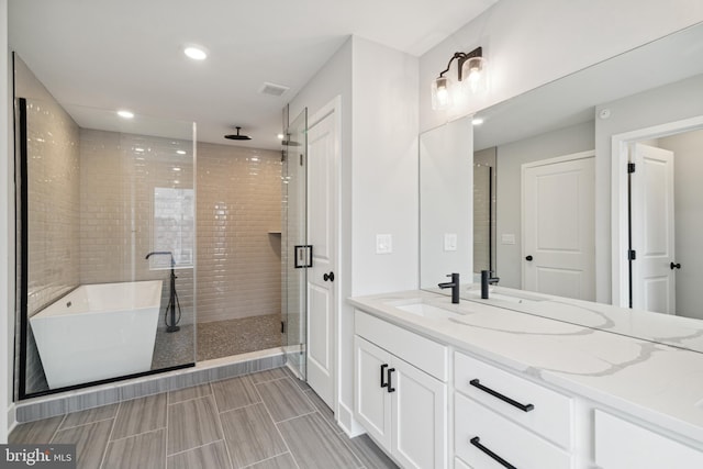 bathroom featuring vanity and separate shower and tub