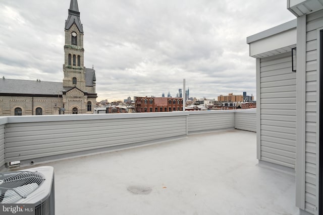 view of patio with a balcony and cooling unit