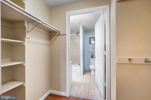 spacious closet featuring light tile patterned flooring