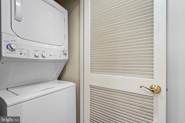 laundry room with stacked washer / dryer and laundry area