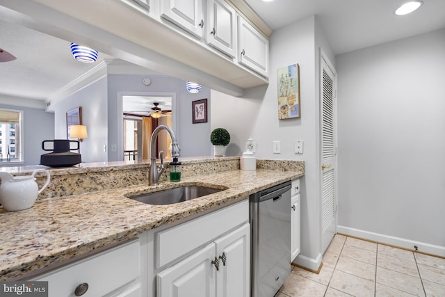 kitchen with light tile patterned floors, white cabinets, dishwasher, light stone counters, and a sink