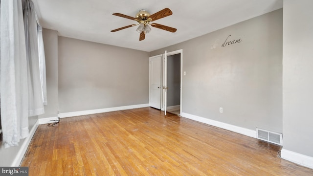 spare room featuring light hardwood / wood-style floors and ceiling fan