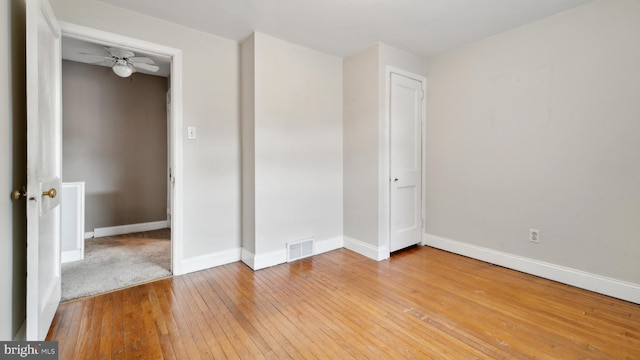 unfurnished room with ceiling fan and light hardwood / wood-style floors