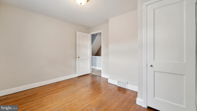 unfurnished room featuring hardwood / wood-style flooring